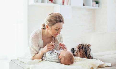 women with baby and dog